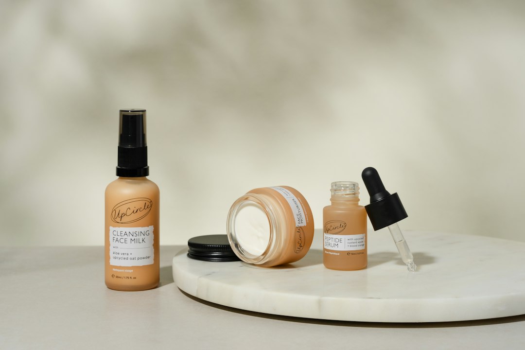 Luxurious skincare essentials by UpCircle featuring Cleansing Face Milk, Moisturizer, and Peptide Serum. Crafted with natural, vegan, and upcycled ingredients, these products provide gentle cleansing, deep hydration, and rejuvenating benefits. Perfect for an eco-conscious beauty routine. Styled on a minimalist marble tray with a soft, neutral background for a clean and elegant aesthetic.